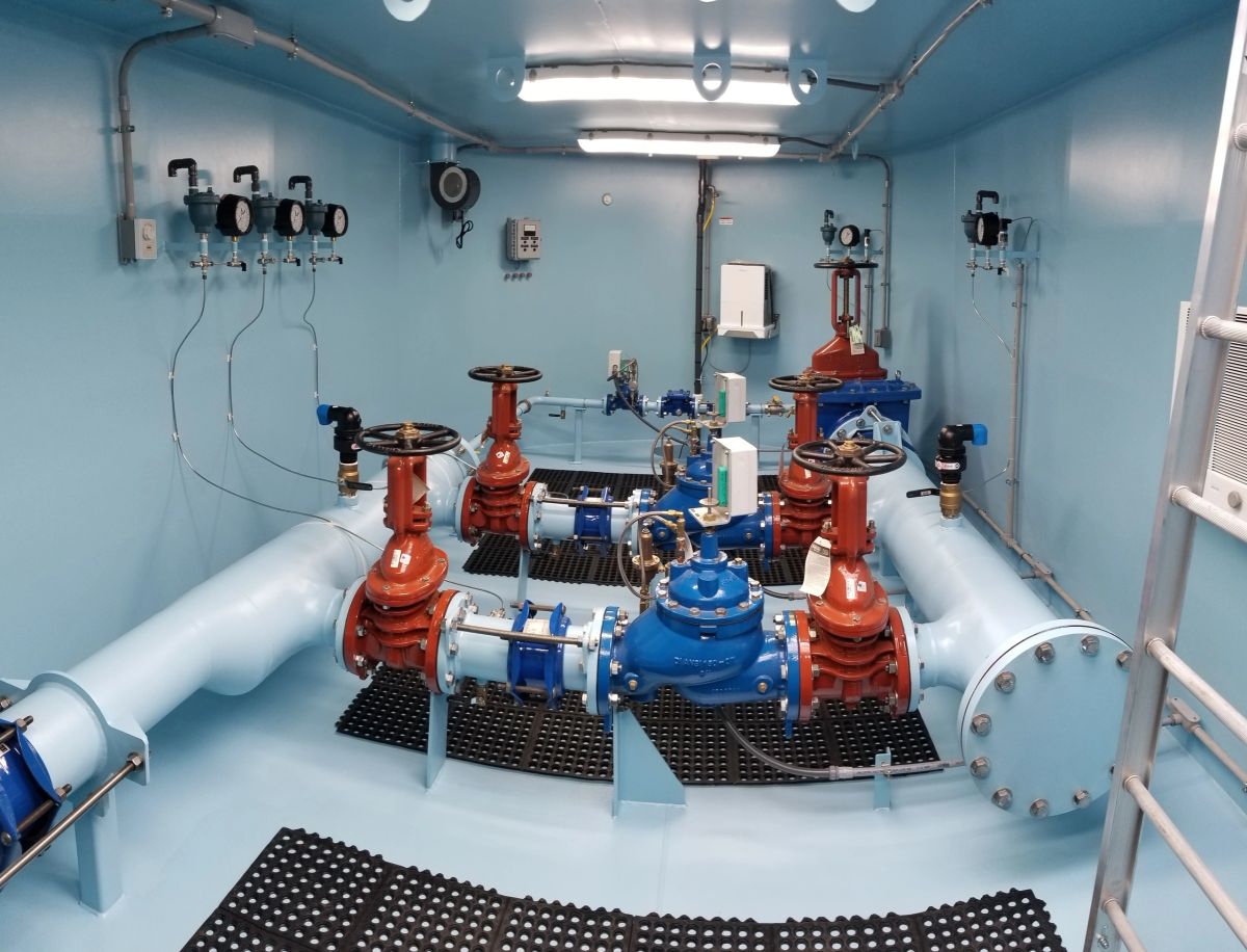 Pre-piped water control vault with pressure-reducing and check valve assembly